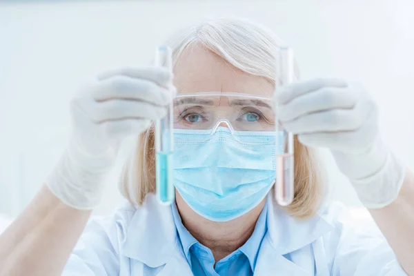 Senior chemist with test tubes — Stock Photo