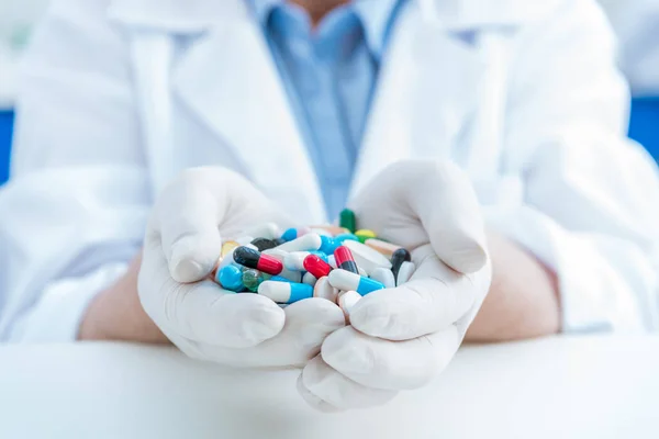 Scientist holding medicines — Stock Photo