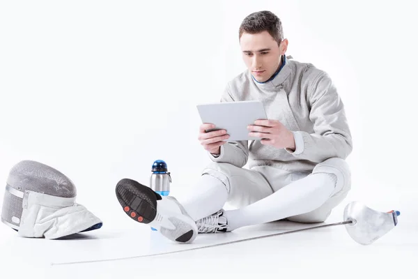 Fencer using digital tablet — Stock Photo