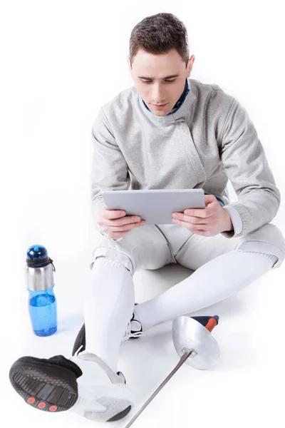 Fencer using digital tablet — Stock Photo