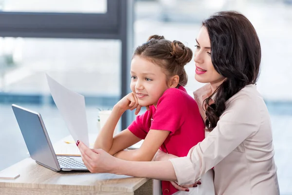 Mother and daughter at workplace — Stock Photo