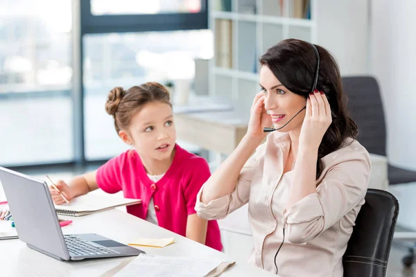 Mother and daughter at workplace — Stock Photo