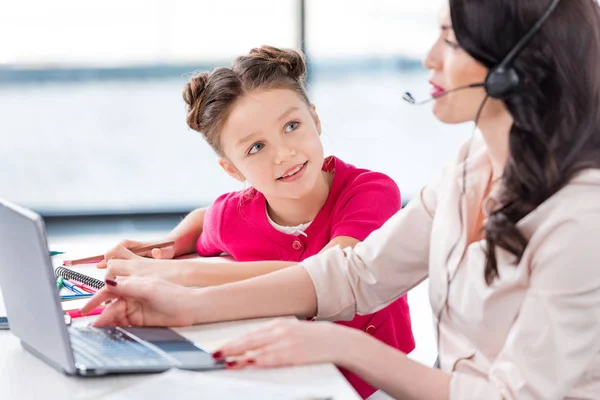 Mother and daughter at workplace — Stock Photo