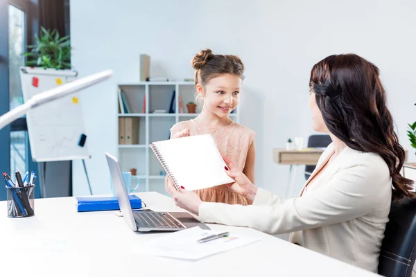 Daughter showing drawing album — Stock Photo