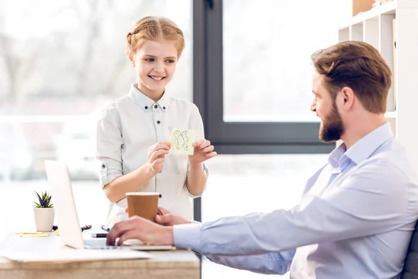 Businessman with daughter in office — Stock Photo