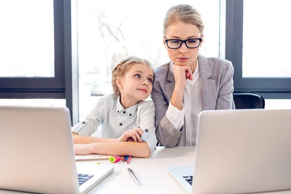 Mother and daughter with laptops — Stock Photo