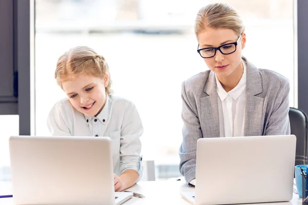 Mother and daughter with laptops — Stock Photo