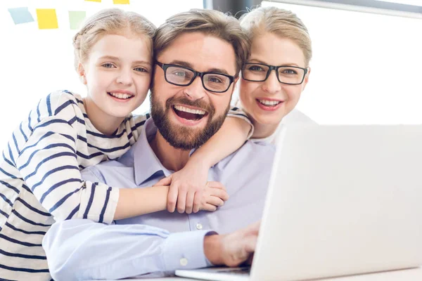 Father, mother and daughter hugging — Stock Photo