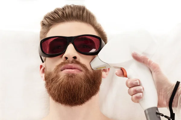 Man receiving laser skin care — Stock Photo