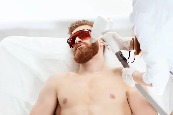 Man receiving laser skin care — Stock Photo