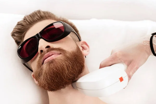 Man receiving laser skin care — Stock Photo