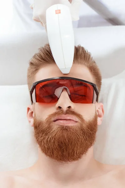 Man receiving laser skin care — Stock Photo