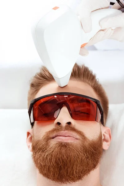 Man receiving laser skin care — Stock Photo