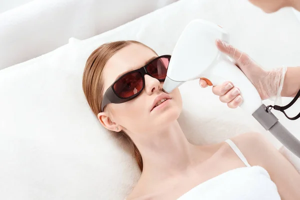 Woman receiving laser skin care — Stock Photo