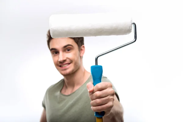 Man holding paint roller — Stock Photo