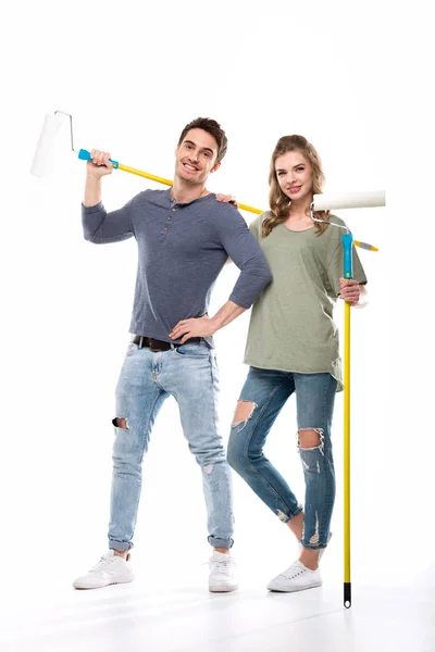 Couple holding paint rollers — Stock Photo