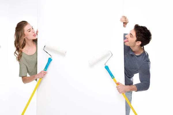 Couple avec rouleaux de peinture et carte — Photo de stock