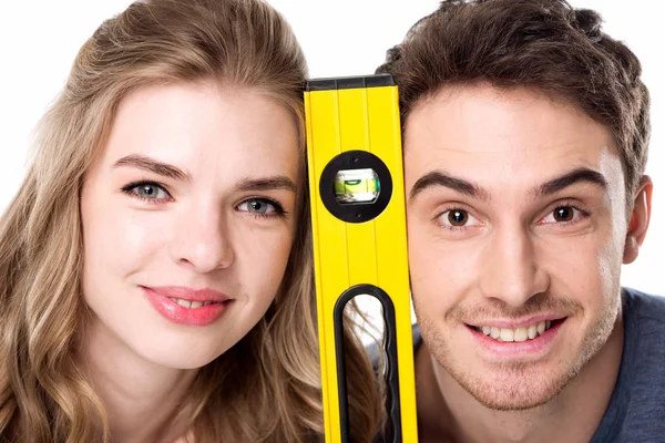 Couple with level tool — Stock Photo