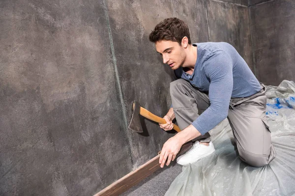 Young laborer repairing floor — Stock Photo