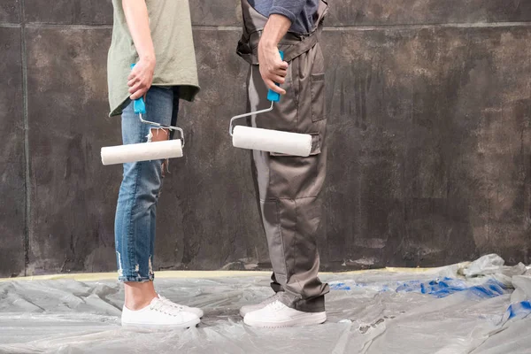 Couple with paint rollers — Stock Photo