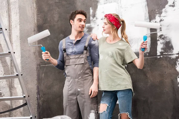 Couple with paint rollers — Stock Photo