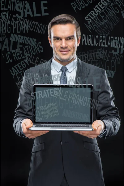 Businessman with laptop computer — Stock Photo