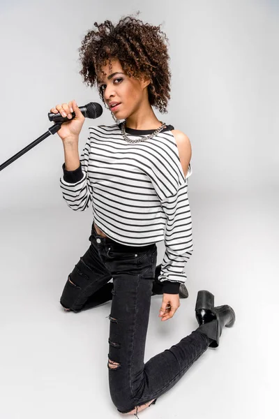 Jeune chanteuse avec microphone — Photo de stock