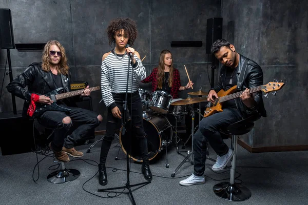 Rock band rehearsing in studio — Stock Photo