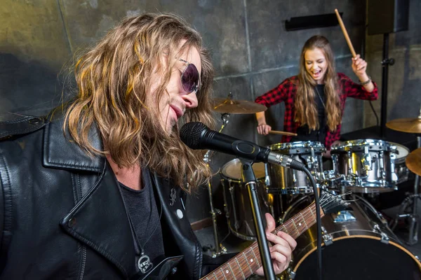 Rock band rehearsing in studio — Stock Photo