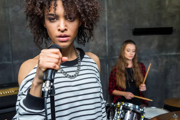 Rock band rehearsing in studio — Stock Photo