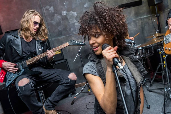 Rock band rehearsing in studio — Stock Photo