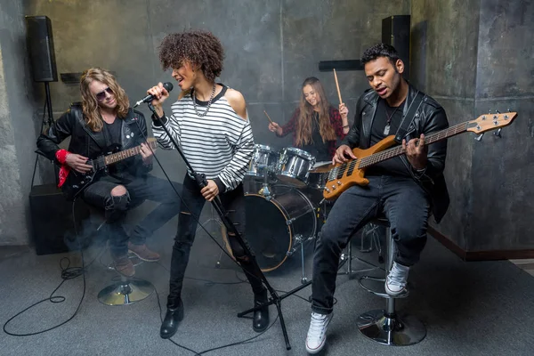 Rock band rehearsing in studio — Stock Photo