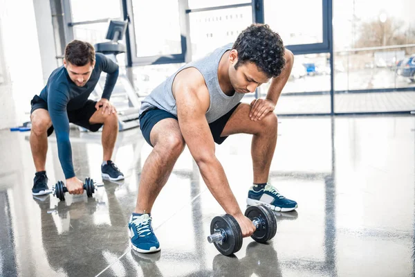 Workout with dumbbells at gym — Stock Photo