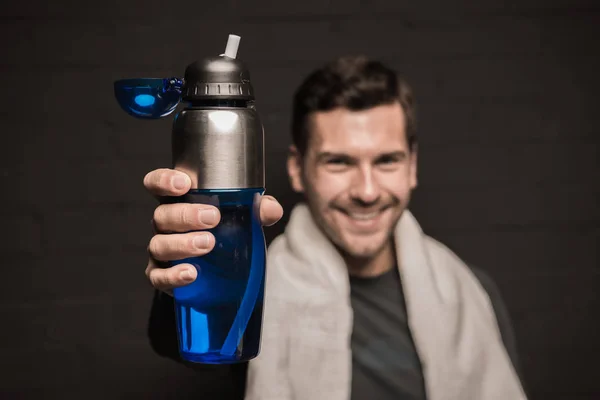 Man holding bottle in hand — Stock Photo