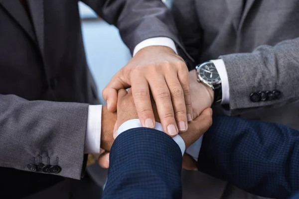 Businesspeople stacking hands — Stock Photo