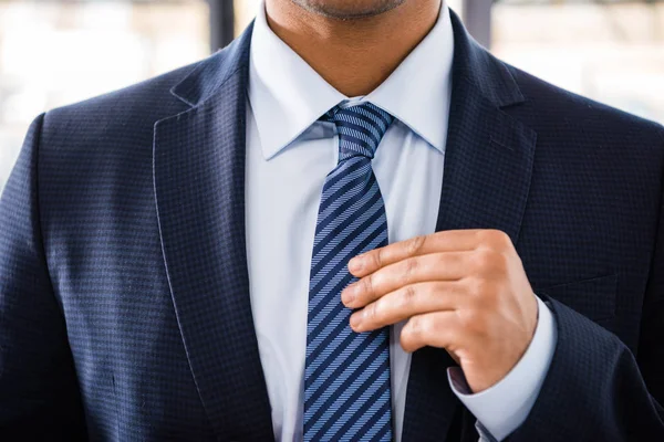 Businessman tying necktie — Stock Photo