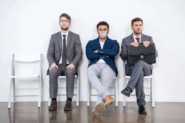 Businessmen sitting on chairs — Stock Photo