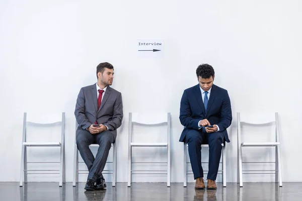 Businessmen sitting on chairs — Stock Photo