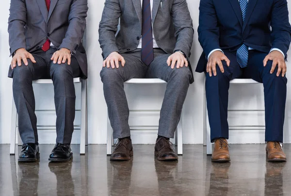 Businessmen sitting on chairs — Stock Photo