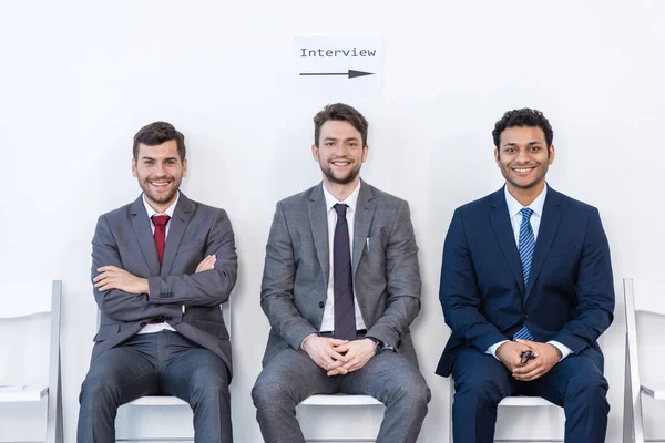 Businessmen sitting on chairs — Stock Photo