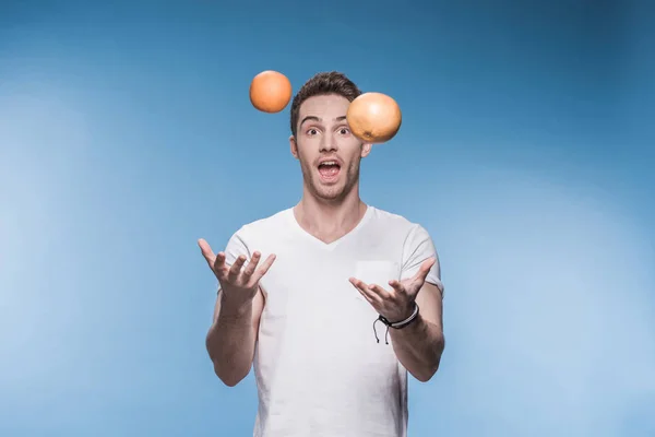 Young man with fruits — Stock Photo