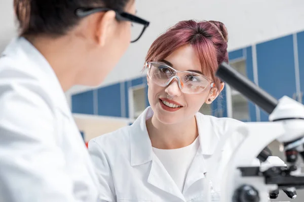 Scientists working together with microscopes — Stock Photo