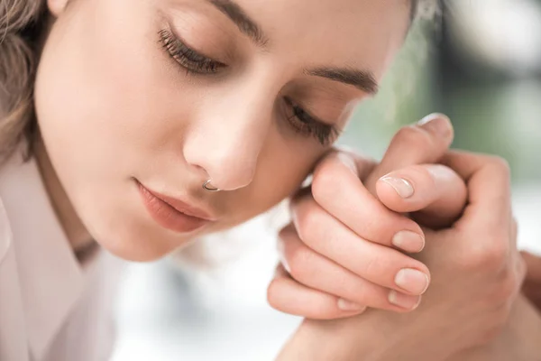 Pensive young woman holding hands — Stock Photo