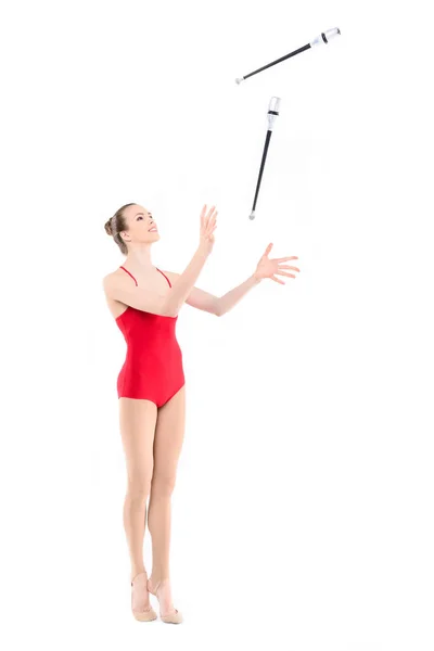 Rhythmic gymnast training with clubs — Stock Photo