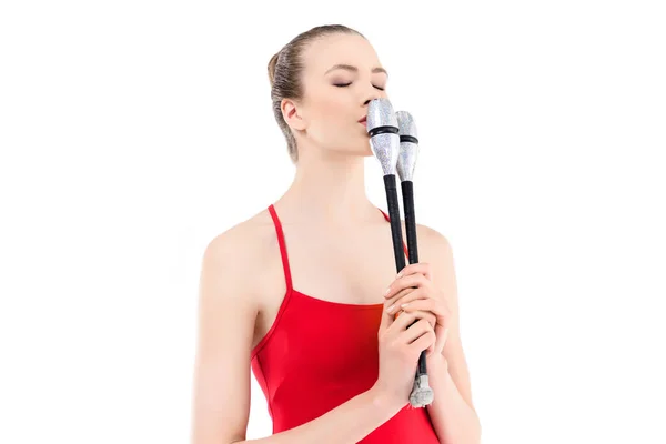 Rhythmic gymnast training with clubs — Stock Photo