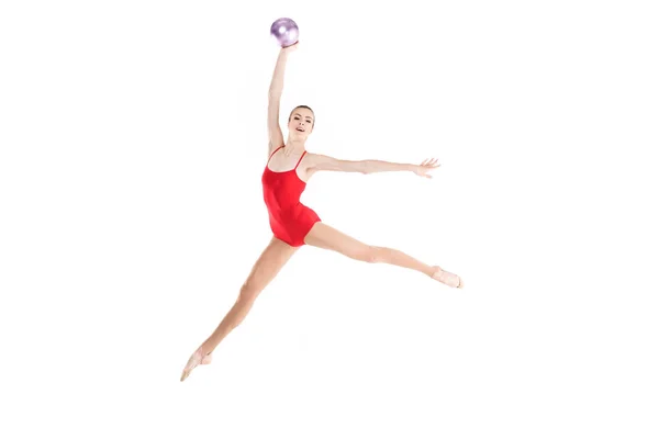 Woman rhythmic gymnast jumping with ball — Stock Photo