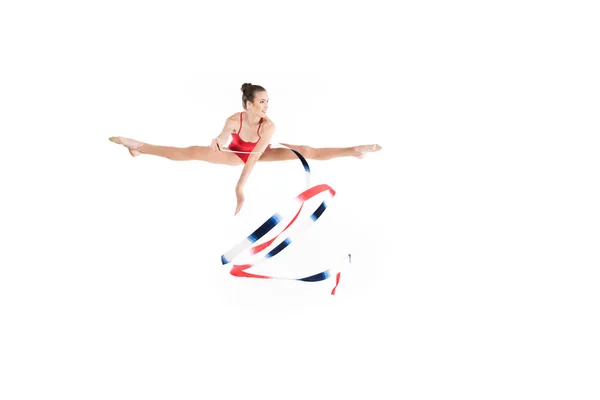 Woman rhythmic gymnast jumping with rope — Stock Photo