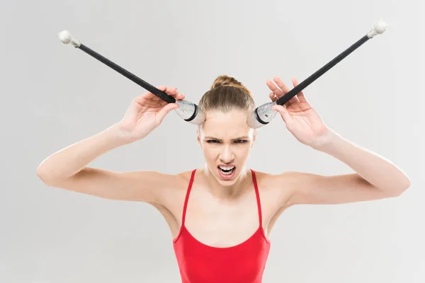 Woman rhythmic gymnast holding clubs — Stock Photo