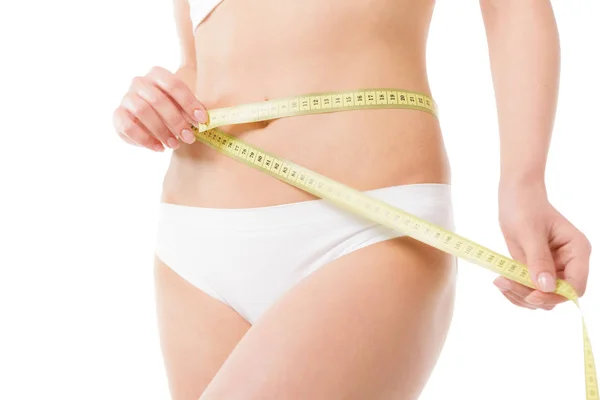 Woman measuring her waistline — Stock Photo