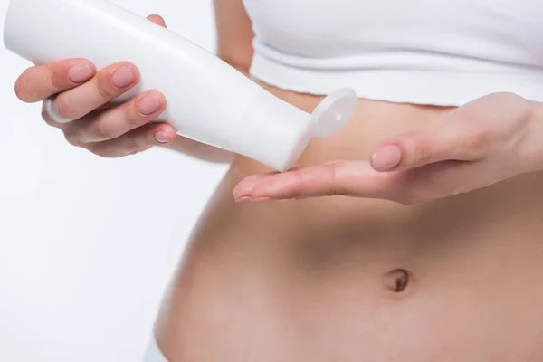 Woman applying body cream — Stock Photo